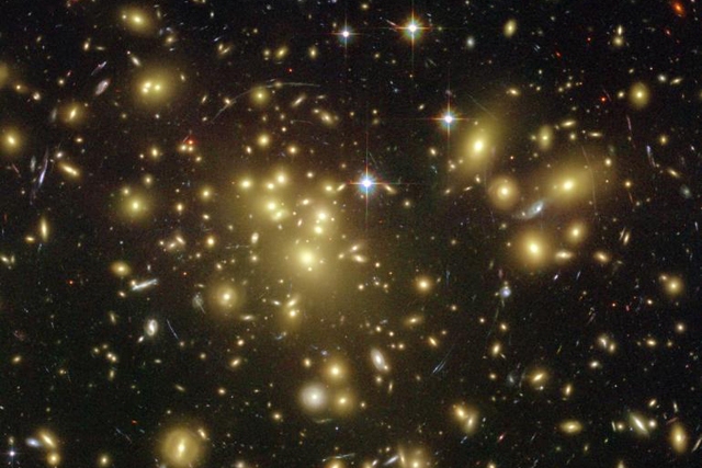 Galaxy Abell 1689's 'Gravitational Lens' Magnifies Light of Distant Galaxies [Credit: NASA, N. Benitez (JHU), T. Broadhurst (Racah Institute of Physics/The Hebrew University), H. Ford (JHU), M. Clampin (STScI), G. Hartig (STScI), G. Illingworth (UCO/Lick Observatory), the ACS Science Team and ESA]